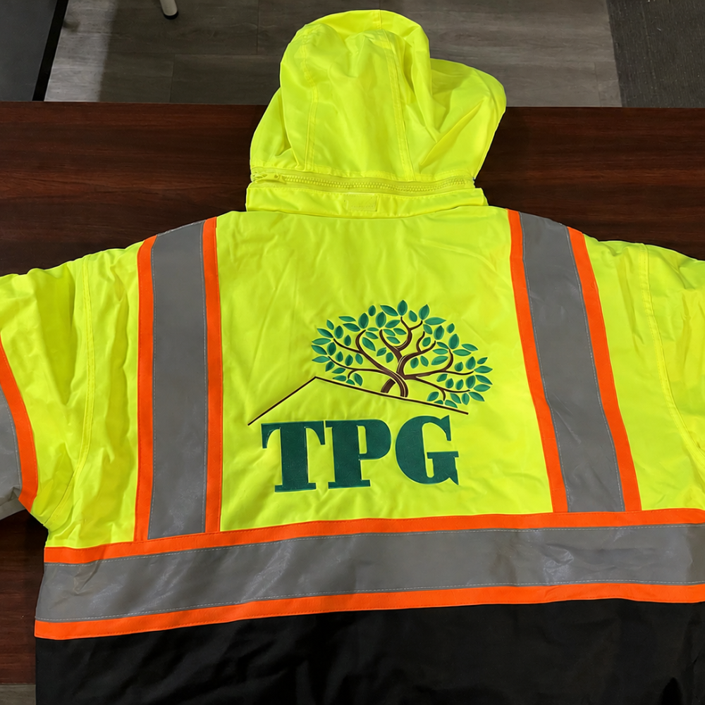 High-visibility jacket with large embroidered TPG logo on the back