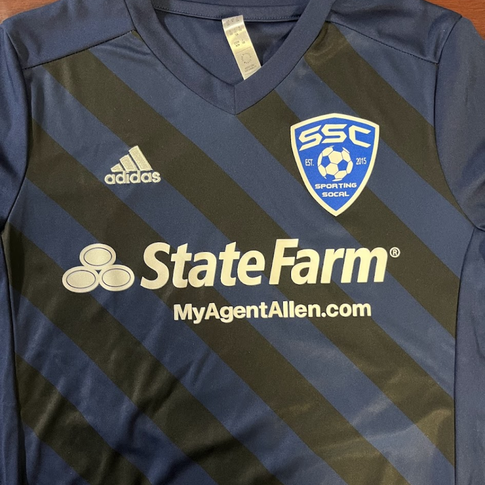Blue and black soccer jersey with sponsor and team logos