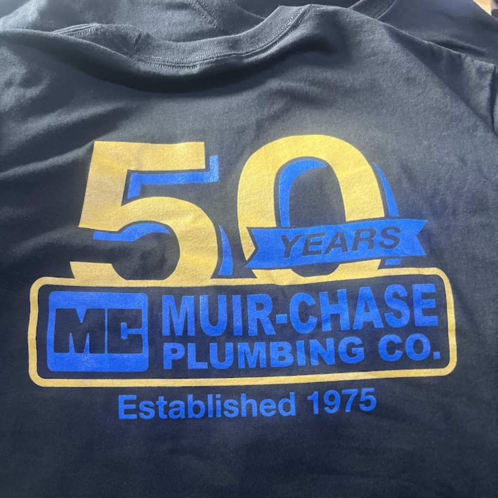 Black shirt with gold and blue Muir-Chase Plumbing Co. 50 years anniversary screen print