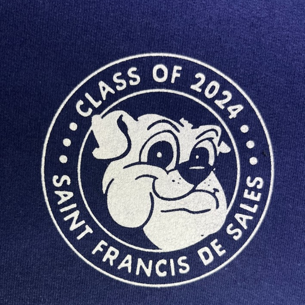 Close-up of Saint Francis de Sales class of 2024 white mascot print on blue fabric